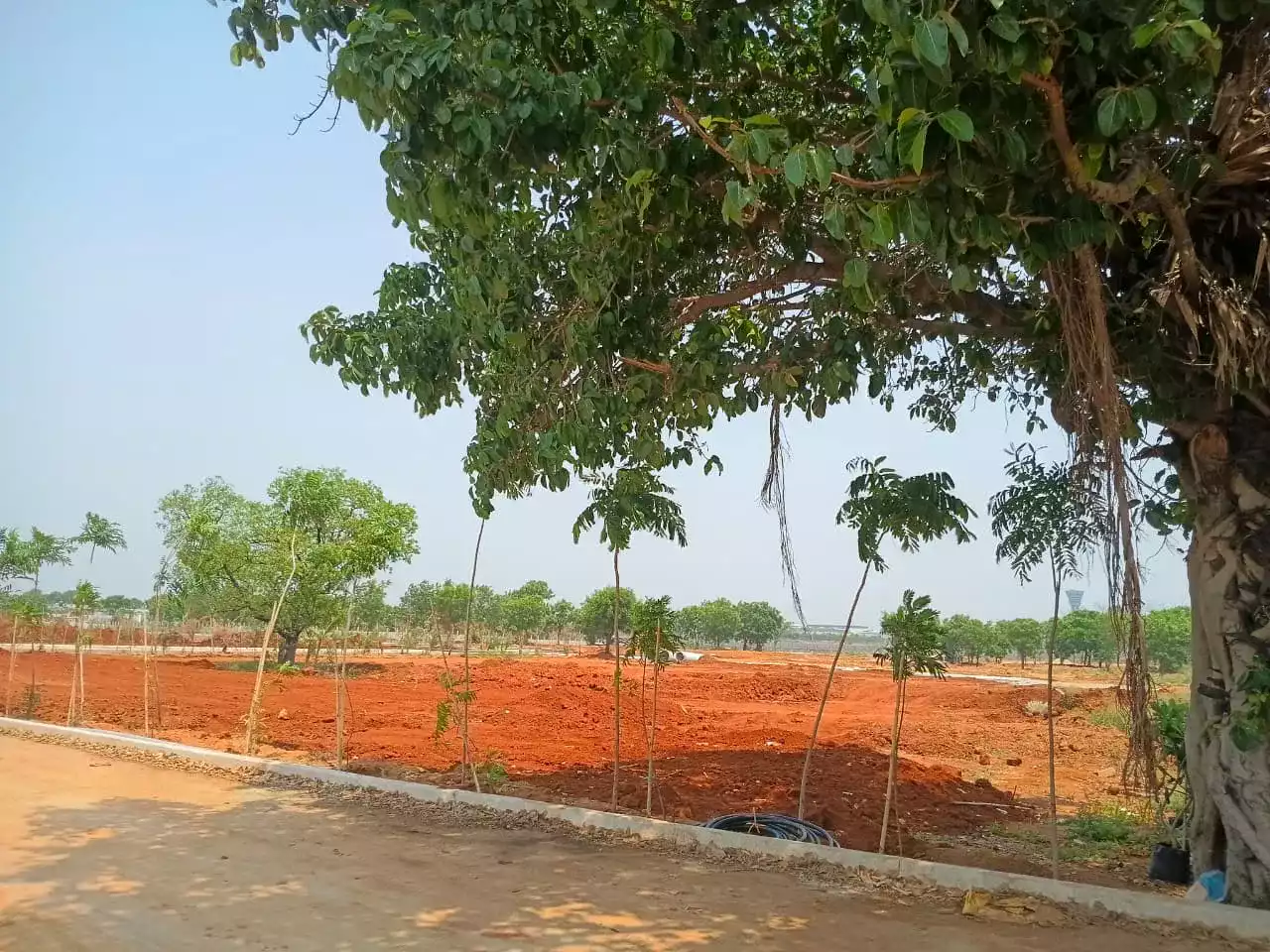 Luxury 1 acre farm plot at Pedda Golconda near Hyderabad Airport with scenic landscaping by KLR Projects